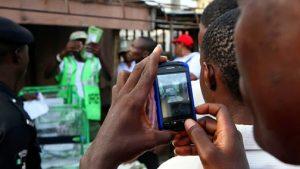 a-man-uses-his-mobile-phone-to-document-the-electoral-process