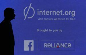 A staff member stands next to a display screen during a joint news conference by Reliance Communications Ltd and Facebook Inc in Mumbai February 10, 2015.   REUTERS/Shailesh Andrade
