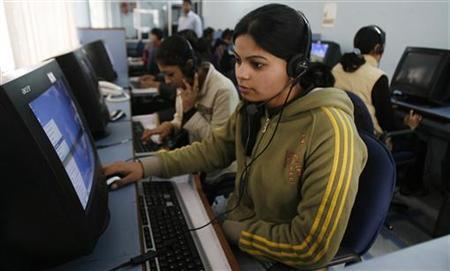 Employees at call centre provide service support to customers in the northeastern Indian city of Siliguri
