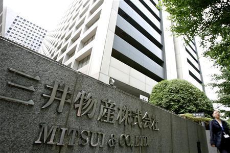 Woman walks past the headquarters of Mitsui & Co., Ltd. in Tokyo