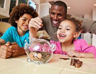 Father, children and piggy bank