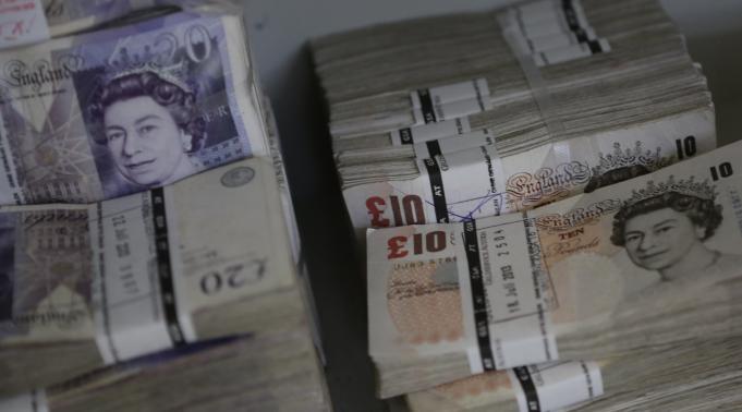 Wads of Pound Sterling banknotes are pictured at the GSA company's headquarters in Vienna