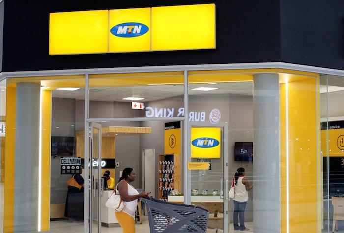 A shopper walks past an MTN shop at mall in Johannesburg