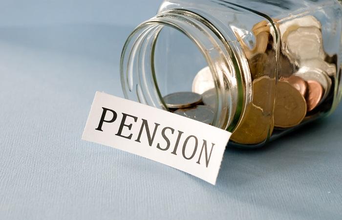 A jar of coins with pension on paper