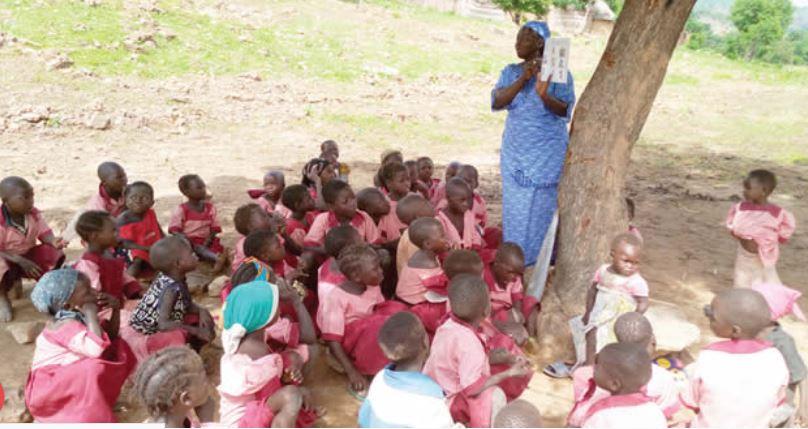 Nigerian children learning under trees