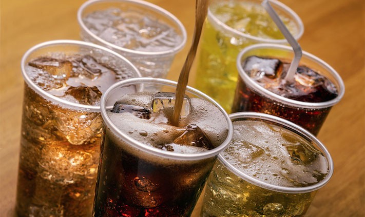 Plastic cups of varying types of carbonated drinks