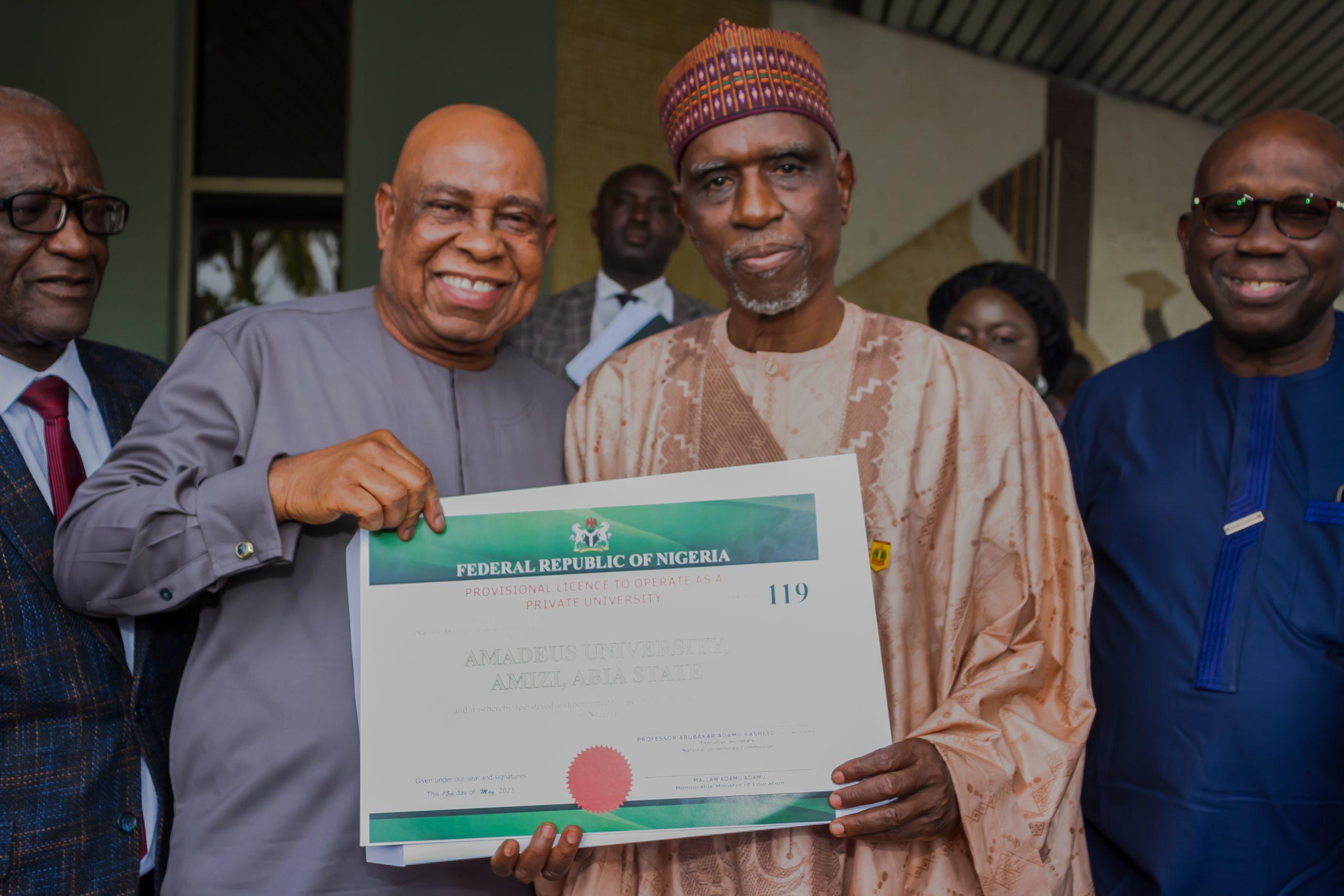 Dr Godwin Nwabunka-CEO-Grooming-Centre-displaying-the-certificate-of-licence-with-the-Executive-Secretary-Professor-Abubakar-Rasheed
