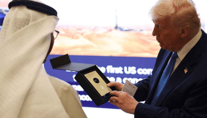 President Donald Trump holds a sample of oil that he was gifted during the final stop of his Gulf visit. Amr Alfiky/Reuters