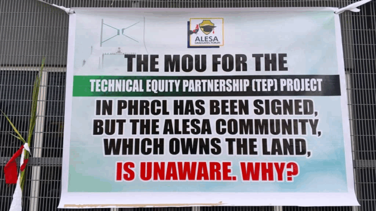 Banner covering the gates plus palm leaves that signify 'no-entry'. 