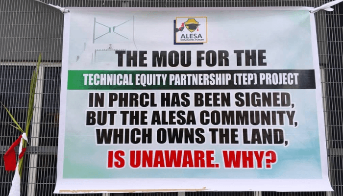 Banner sealing the gates of the PH Refinery