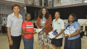 Chioma Obianuju Ojukwu (middle) with other ICAN leaders, sharing materials to students